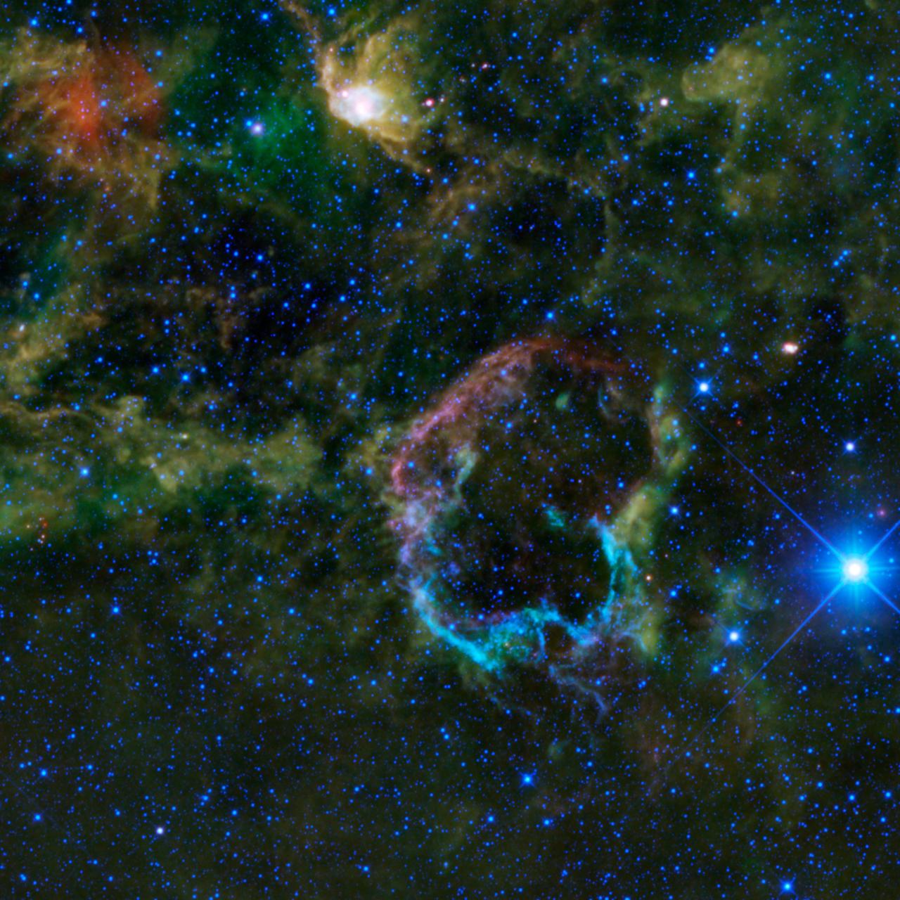 This oddly colorful nebula is the supernova remnant IC 443 as seen by NASA Wide-field Infrared Survey Explorer; the Jellyfish nebula is particularly interesting because it provides a look into how stellar explosions interact with their environment.