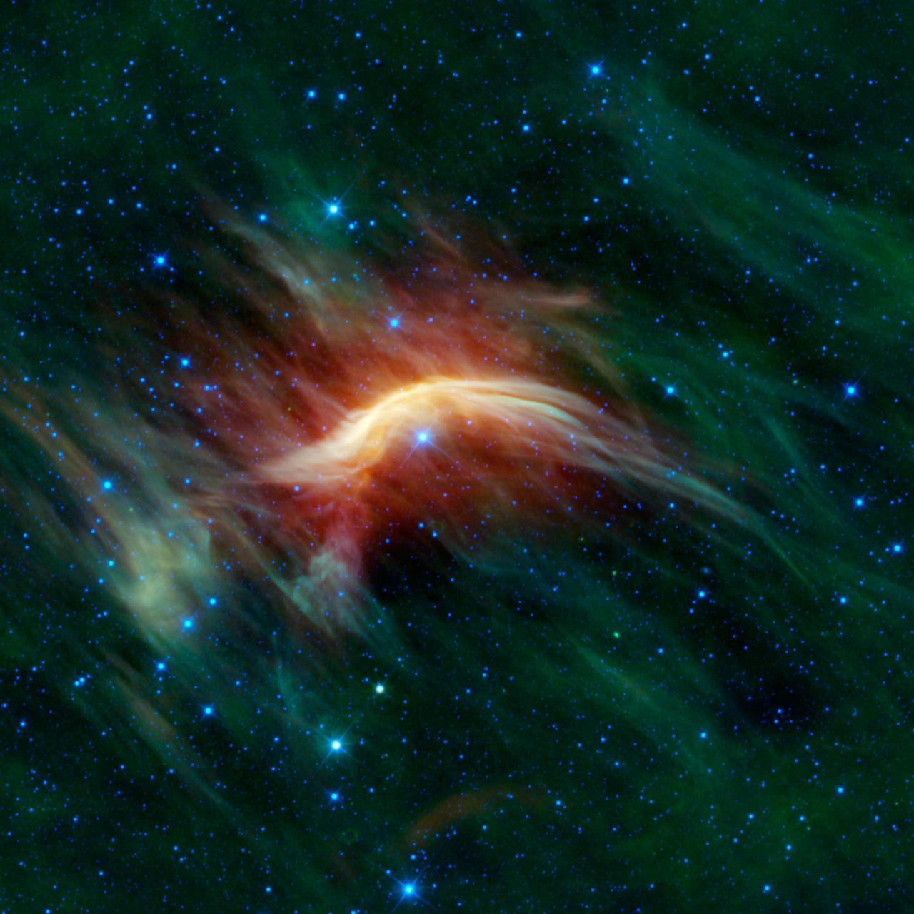 The blue star near the center of this image is Zeta Ophiuchi. Zeta Ophiuchi is actually a very massive, hot, bright blue star plowing its way through a large cloud of interstellar dust and gas in this image from NASA Wide-field Infrared Survey Explorer.