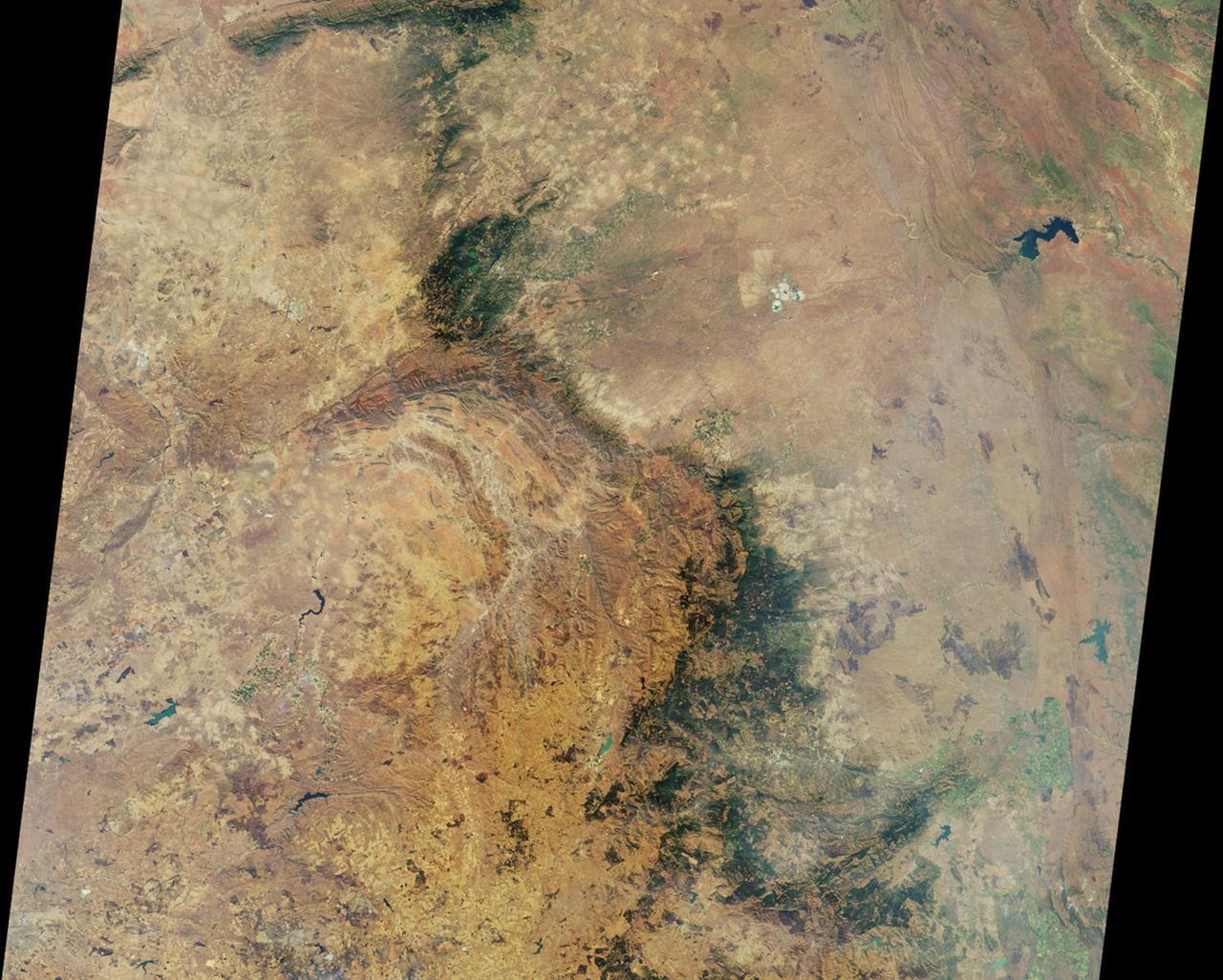 This nadir camera view was captured by NASA Terra spacecraft around Kruger National Park in NE South Africa. The bright white feature is the Palabora Copper Mine, and the water body near upper right is Lake Massingir in Mozambique.