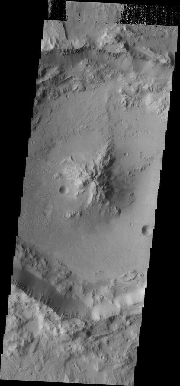 As crater size increases, craters become more complex. This moderate size crater contains a central peak, created by rebound of molten material just following the impact. This image was captured by NASA Mars Odyssey on Sept. 8, 2010.