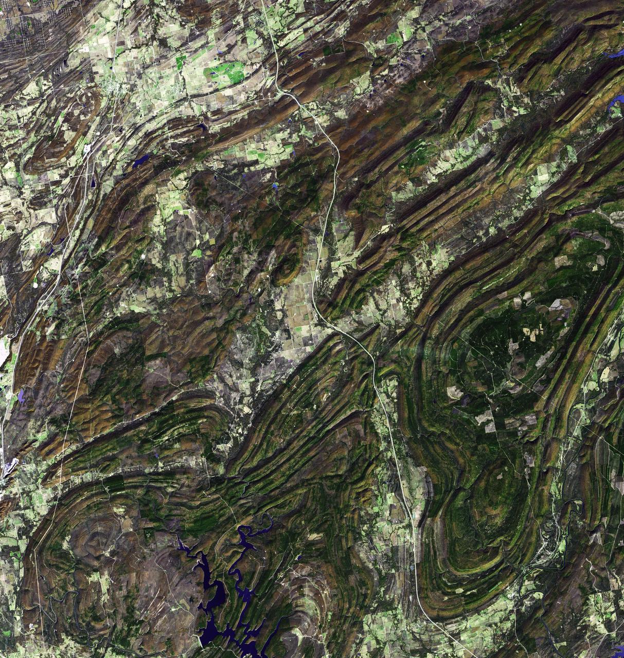 NASA Terra spacecraft captured this image of the Ouachita Mountains in southeast Oklahoma. The Ouachitas are fold mountains, formed about 300 million years ago when the South American Plate drifted northward, colliding with the North American Plate.