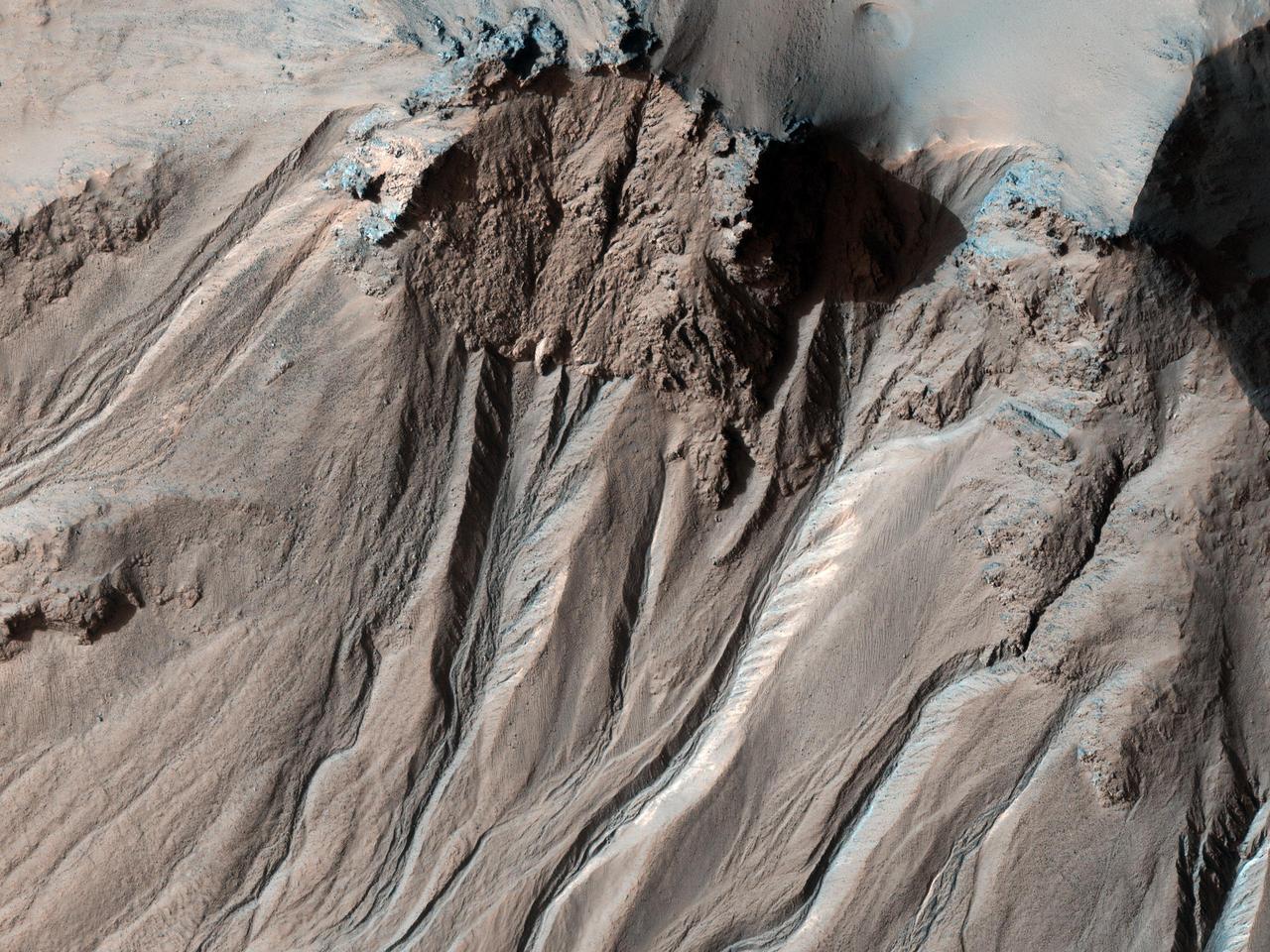 This image from NASA Mars Reconnaissance Orbiter shows the southern latitude Hale Crater, a rather large, pristine elliptical crater possessing sharp features, impact melt bodies ponded throughout the structure and few overprinting impact craters.