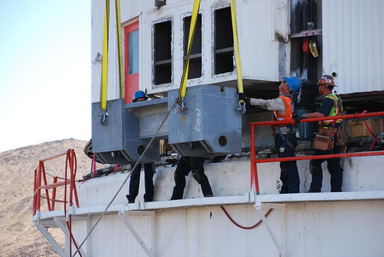 As part of a major refurbishment for the giant Mars antenna at NASA Deep Space Network Goldstone Deep Space Communications Complex, a stringer box is lowered into place.