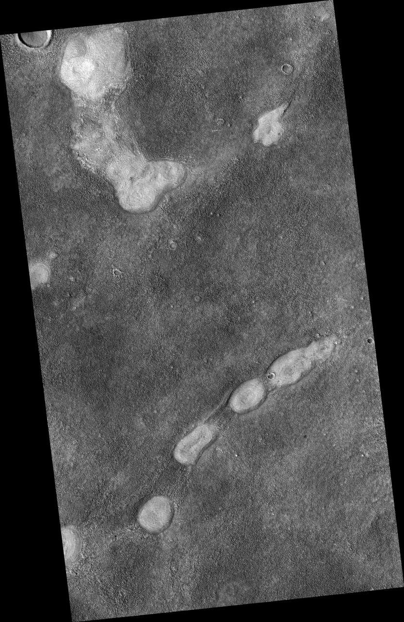 This image from NASA Mars Reconnaissance Orbiter is a proposed future Mars landing site in Acidalia Planitia targets densely occurring mounds thought to be mud volcanoes.