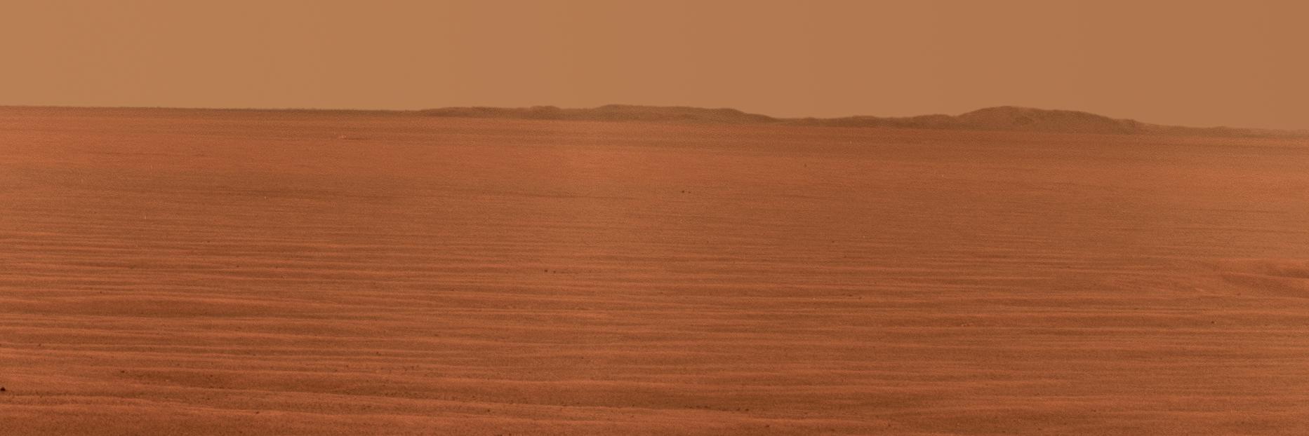 NASA Mars Exploration Rover Opportunity used its panoramic camera to record this eastward horizon view. A portion of Endeavour Crater eastern rim, in the distance, is visible over the Meridiani plain.