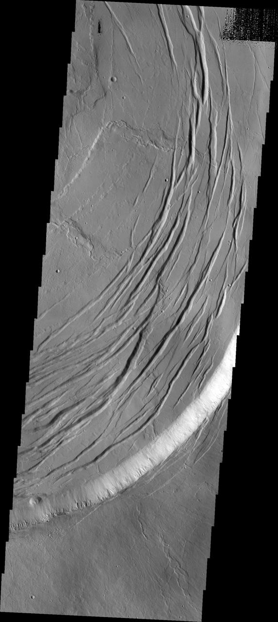 This image captured by NASA Mars Odyssey shows one edge of the complex caldera at the summit of Olympus Mons.