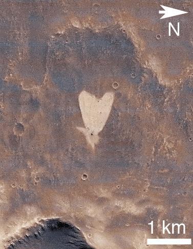 This picture of a heart-shaped feature in Arabia Terra on Mars was taken on May 23, 2010, by NASA Mars Reconnaissance Orbiter. A small impact crater near the tip of the heart is responsible for the formation of the bright, heart-shaped feature.