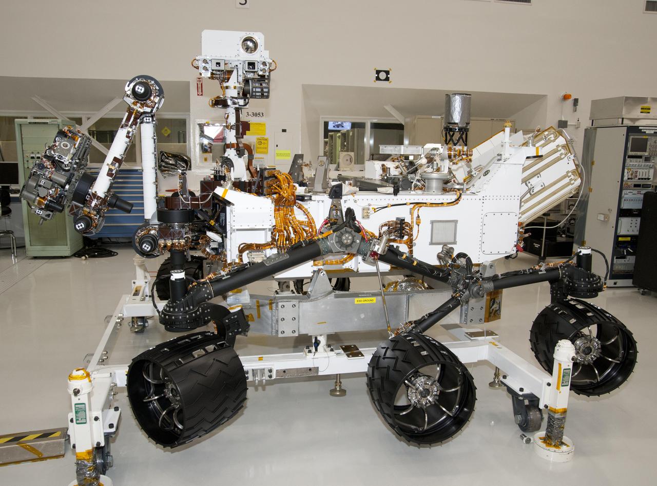 The rover for NASA Mars Science Laboratory mission, named Curiosity, is about 3 meters 10 feet long, not counting the additional length that the rover arm can be extended forward. The front of the rover is on the left in this side view.