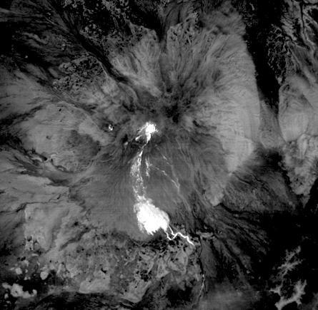 This nighttime thermal infrared image from NASA Terra spacecraft shows Shiveluch volcano, one of the largest and most active volcanoes in Russia Kamchatka Peninsula; the bright, hot summit lava dome is evident in the center of the image.