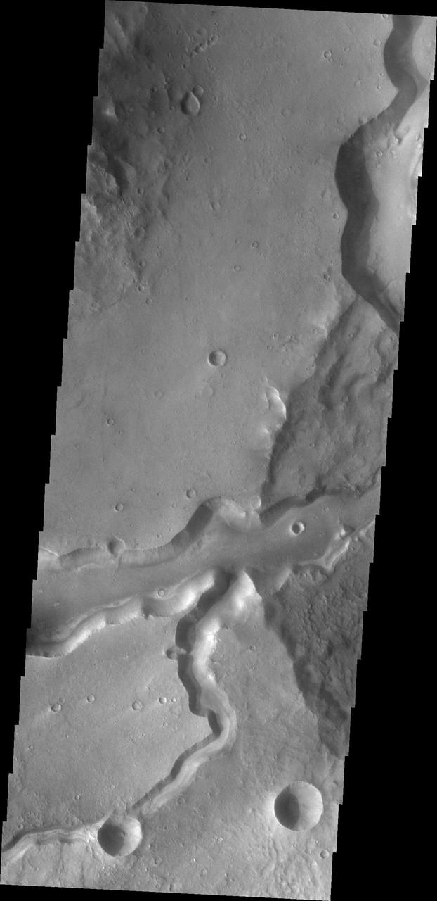 This image from NASA Mars Odyssey shows Bahram Vallis where it enters Waspam Crater. Bahram Vallis exits the crater to the north a short distance from this location along the rim of Waspam Crater.
