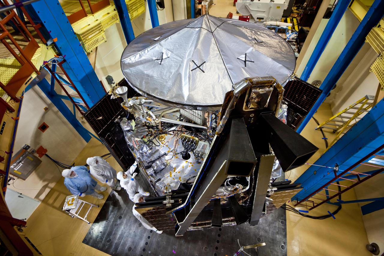 This image shows NASA Juno spacecraft undergoing environmental testing at Lockheed Martin Space Systems on Jan. 26, 2011. All 3 solar array wings are installed and stowed, and the large high-gain antenna is in place on the top of the avionics vault.