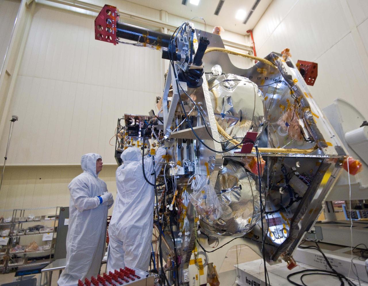 Technicians install components that will aid with guidance, navigation and control of NASA Juno spacecraft.
