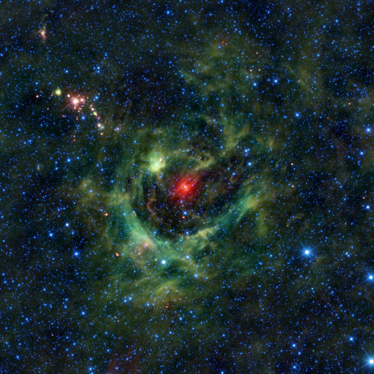 This image from NASA Wide-field Infrared Survey Explorer, or WISE, features a region of star birth wrapped in a blanket of dust, colored green in this infrared view.