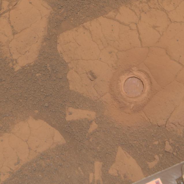 NASA Mars Exploration Rover Opportunity used its rock abrasion tool on a rock informally named Gagarin. This approximately true color image shows the circular mark created where the tool exposed the interior of the rock at a target called Yuri.