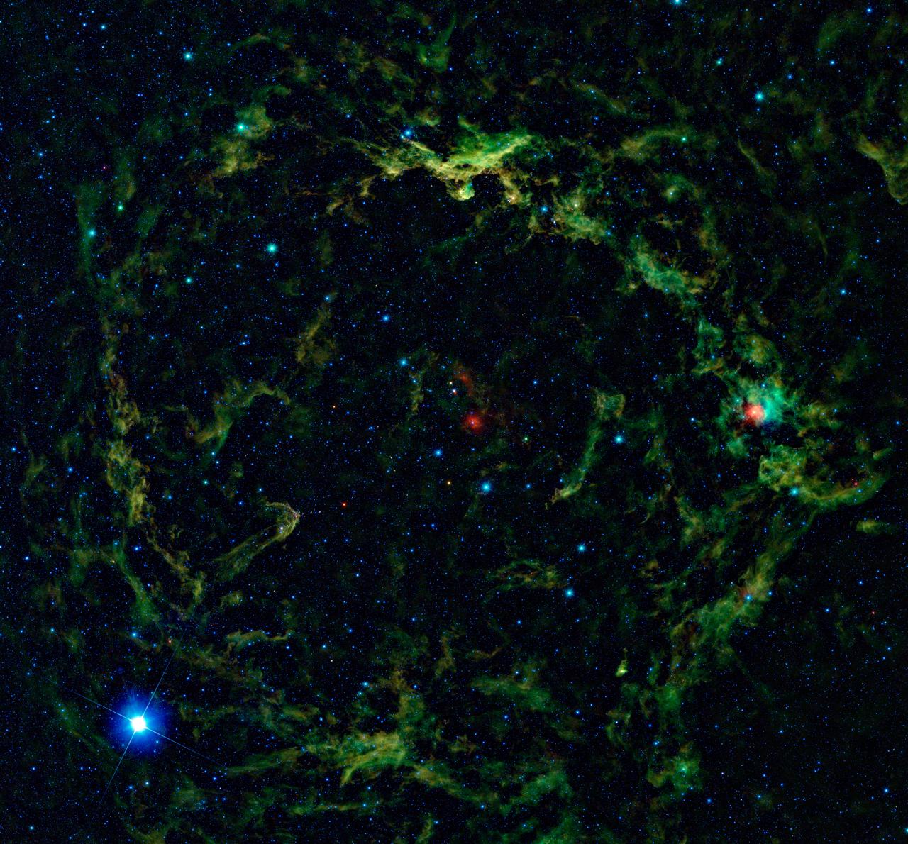 NASA Wide-field Infrared Survey Explorer, shows a giant nebula around Lambda Orionis, inflating Orion head to huge proportions.