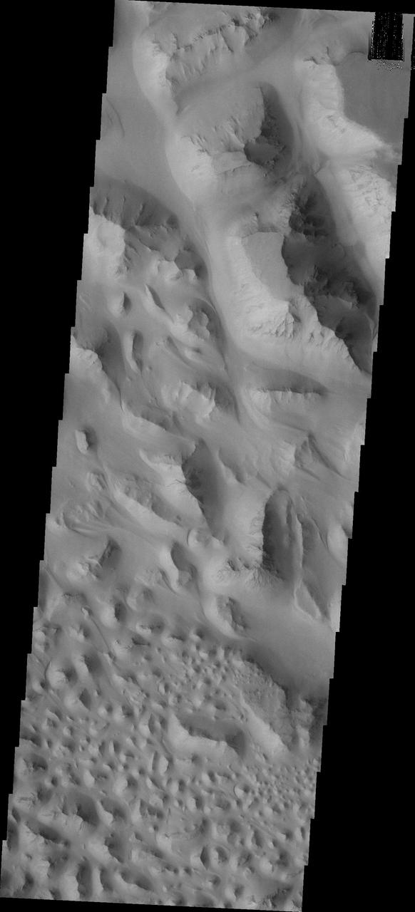 The floor of Eos Chasma is composed of thousands of small hills; this type of terrain is called chaos. This image from NASA Mars Odyssey and shows a small portion of Eos Chaos.