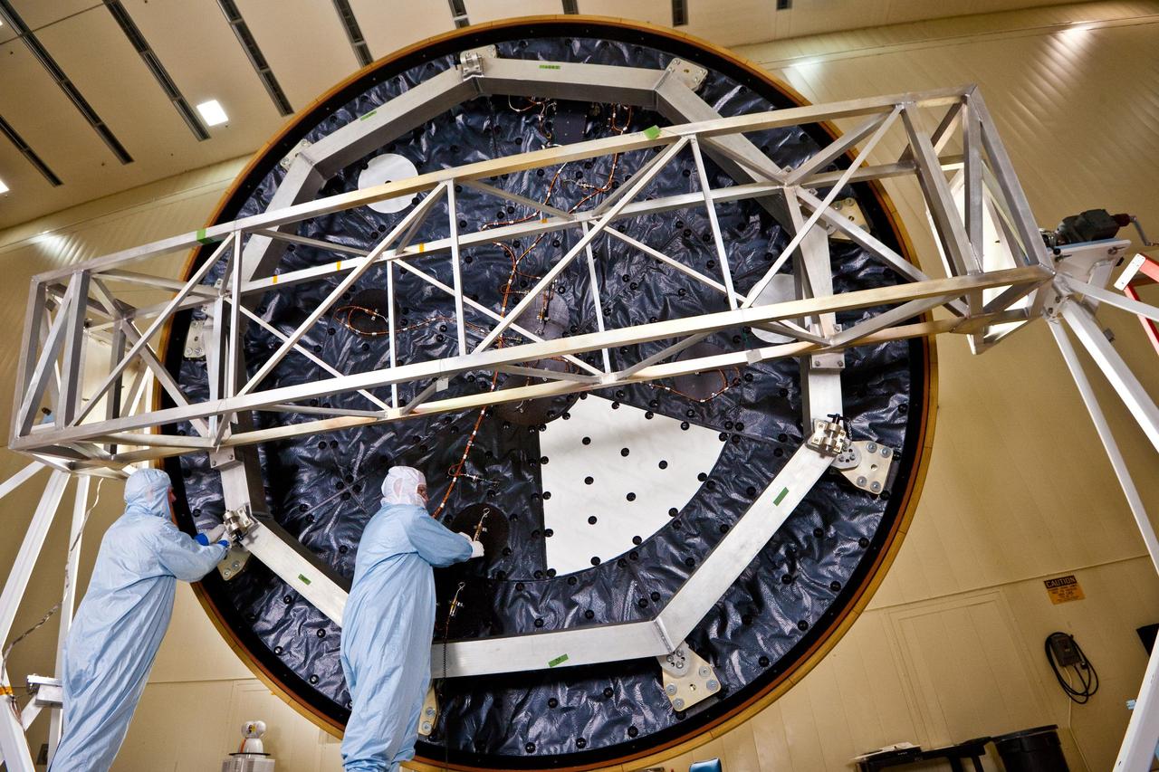 Technicians at Lockheed Martin Space Systems, Denver, prepare the heat shield for NASA Mars Science Laboratory. With a diameter of 4.5 meters nearly 15 feet, this heat shield is the largest ever built for a planetary mission.