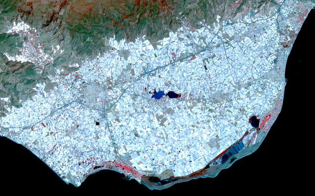Surrounding the town of El Ejido, Almeria Province, southern Spain is a sea of greenhouses, stretching for tens of kilometers as shown in this image from NASA Terra spacecraft.