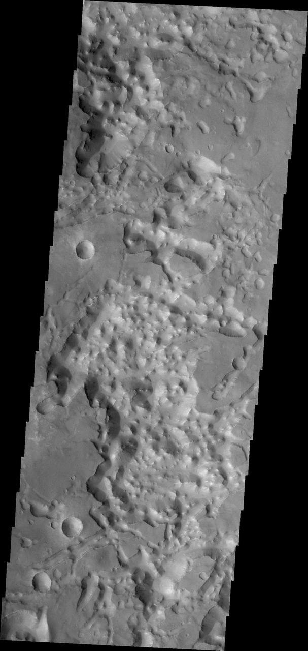 The eastern end of Valles Marineris opens into huge low lying channels filled with the mound and valley terrain called chaos. This image from NASA 2001 Mars Odyssey shows part of Eos Chaos.