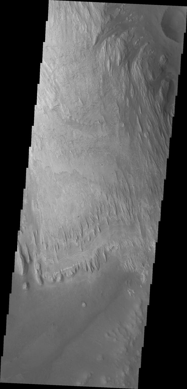Wind has eroded the deposit on the floor of Gale Crater in this image captured by NASA 2001 Mars Odyssey.