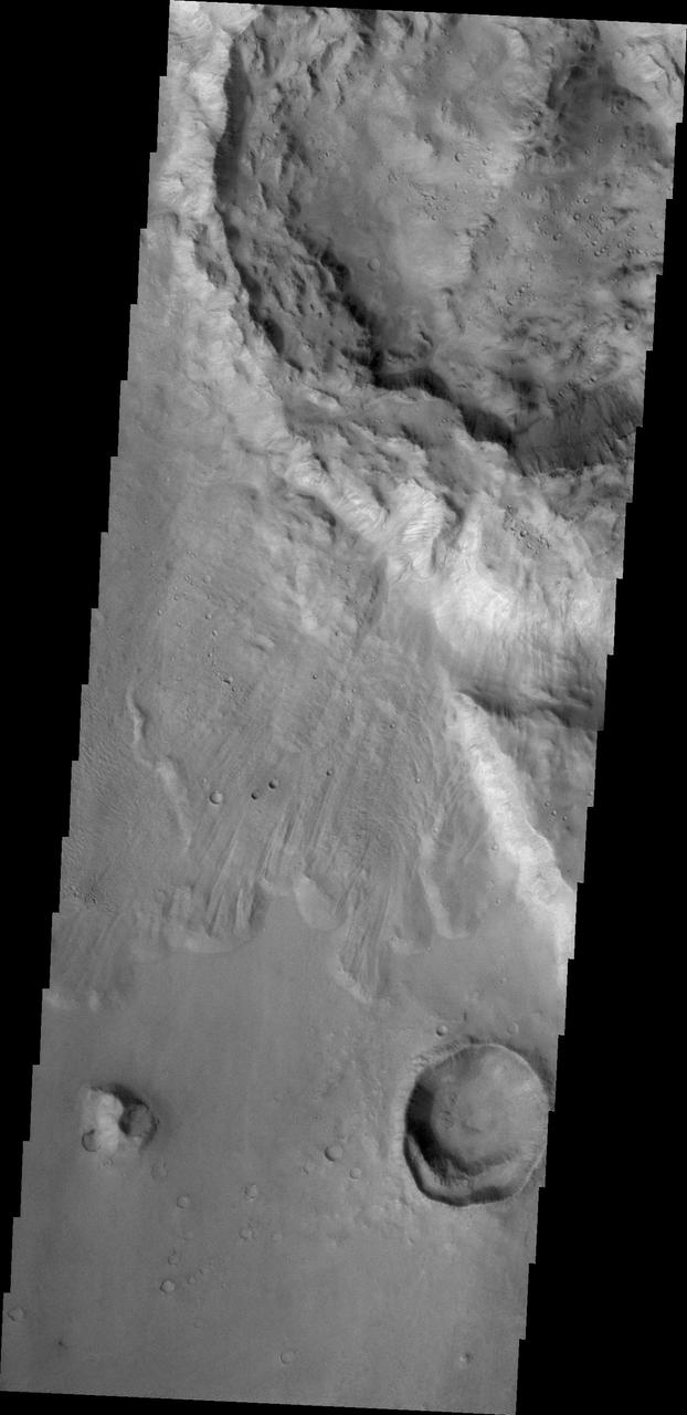 The pristine nature of this crater and its ejecta indicate that it is younger than the outflow channel where it is located. This image is from NASA 2001 Mars Odyssey.