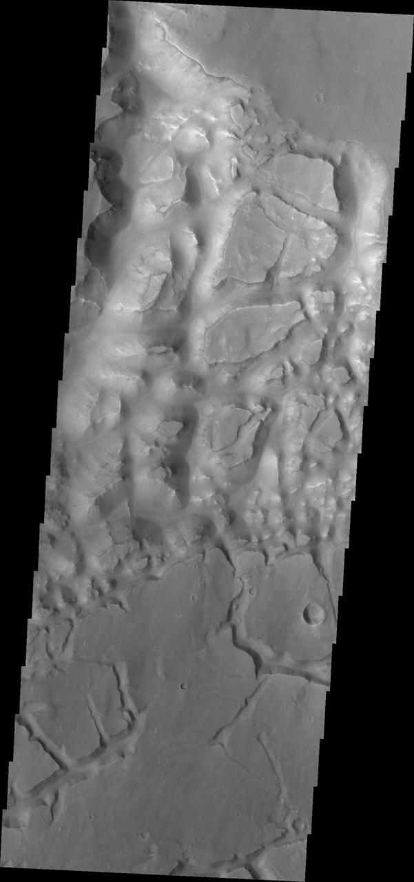 This image from NASA 2001 Mars Odyssey spacecraft shows part of the mesa and valley terrain called chaos. This region of chaos is near the far eastern end of Valles Marineris.
