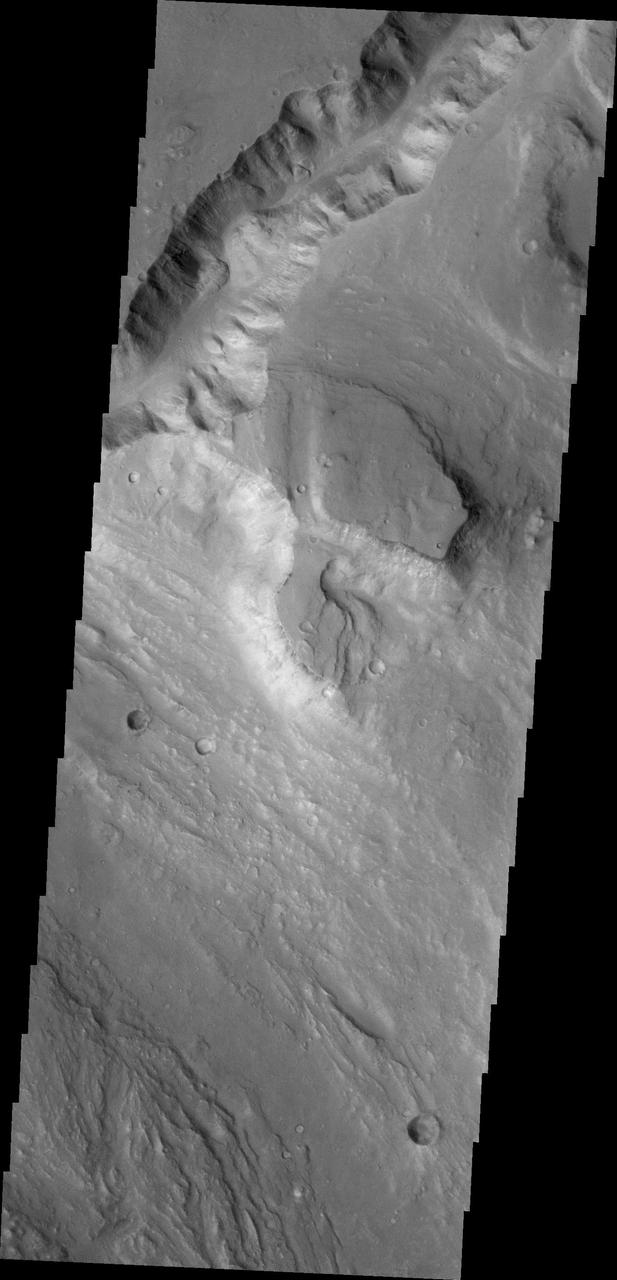 The channel at the top of this image captured by NASA 2001 Mars Odyssey spacecraft runs between Galilaei Crater and the main channel on the northeastern side of Hydaspis Chaos.