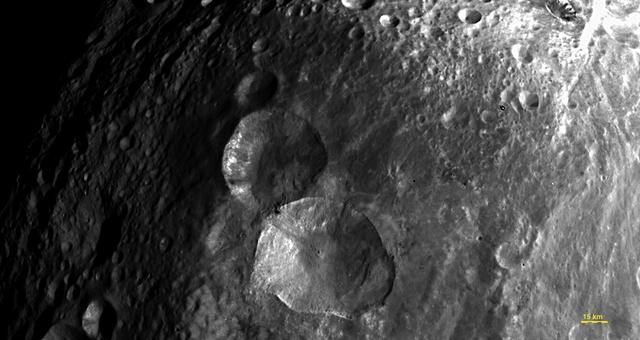 In this image, obtained by the framing camera on NASA Dawn spacecraft, a set of three craters, informally nicknamed Snowman by the camera team members, is located in the northern hemisphere of Vesta.