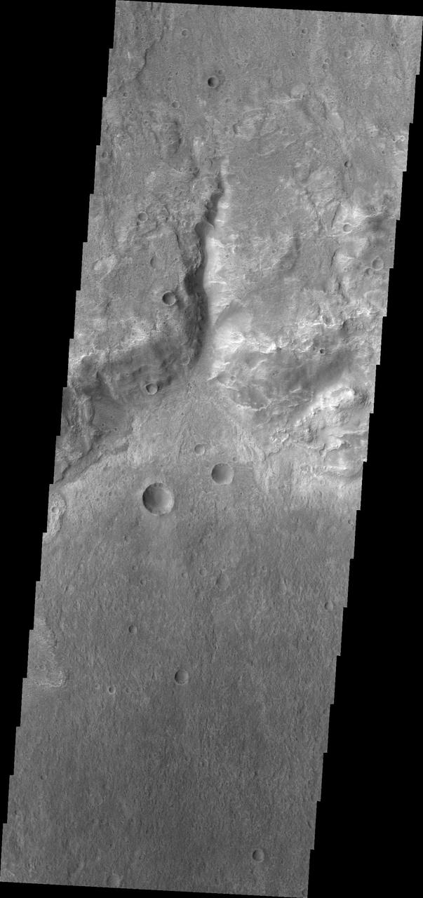 This small channel dissects the rim of an unnamed crater north of Terby Crater and Hellas Planitia as seen by NASA 2001 Mars Odyssey spacecraft.