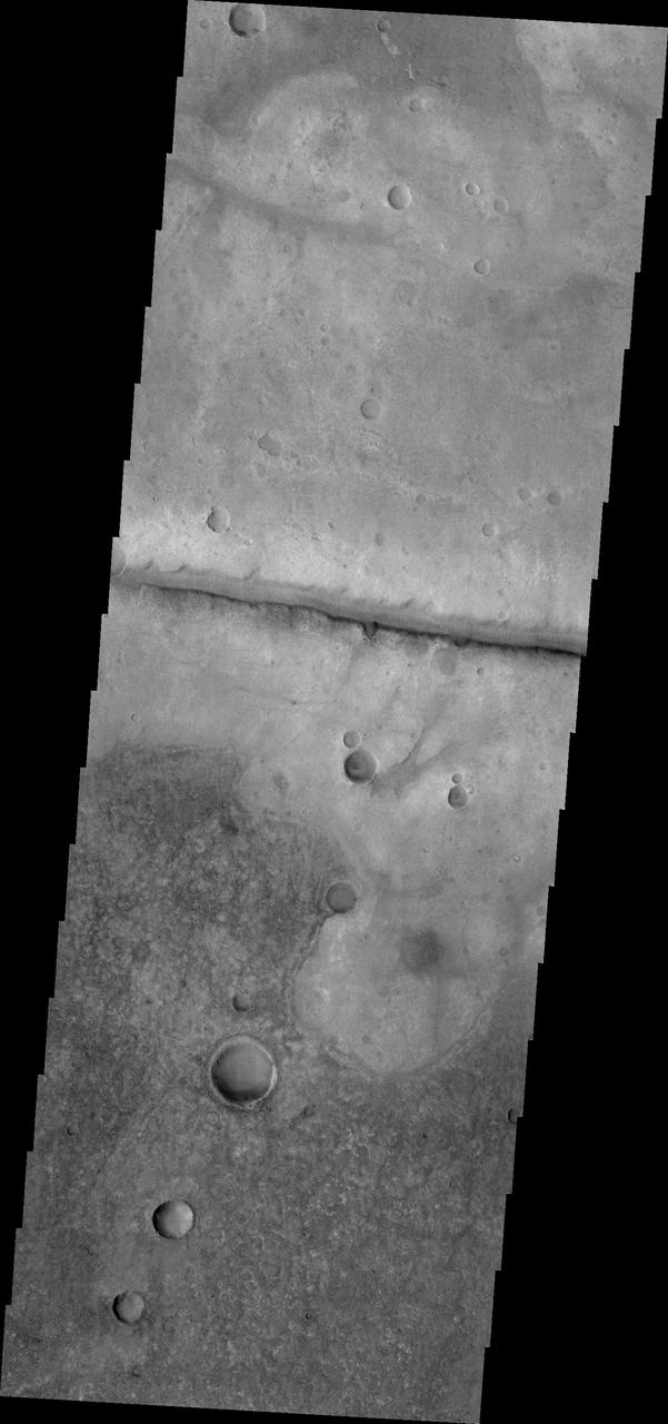 This image from NASA 2001 Mars Odyssey spacecraft shows a fracture north of Argyre Planitia. Note the dunes within the channel.