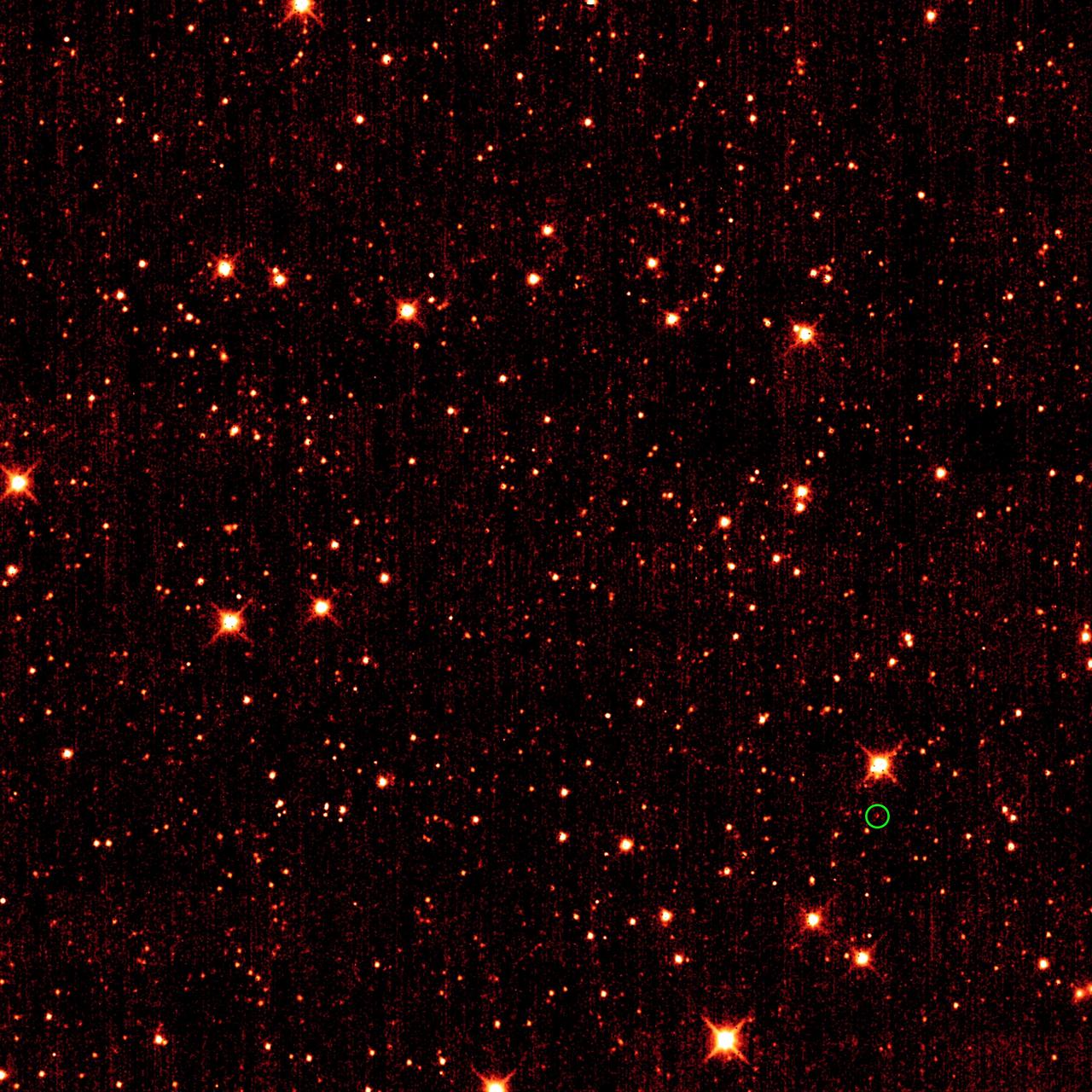 Asteroid 2010 TK7, the first known Earth Trojan asteroid, is circled in green, in this single frame taken by NASA Wide-field Infrared Survey Explorer. The majority of the other dots are stars or galaxies far beyond our solar system. 
