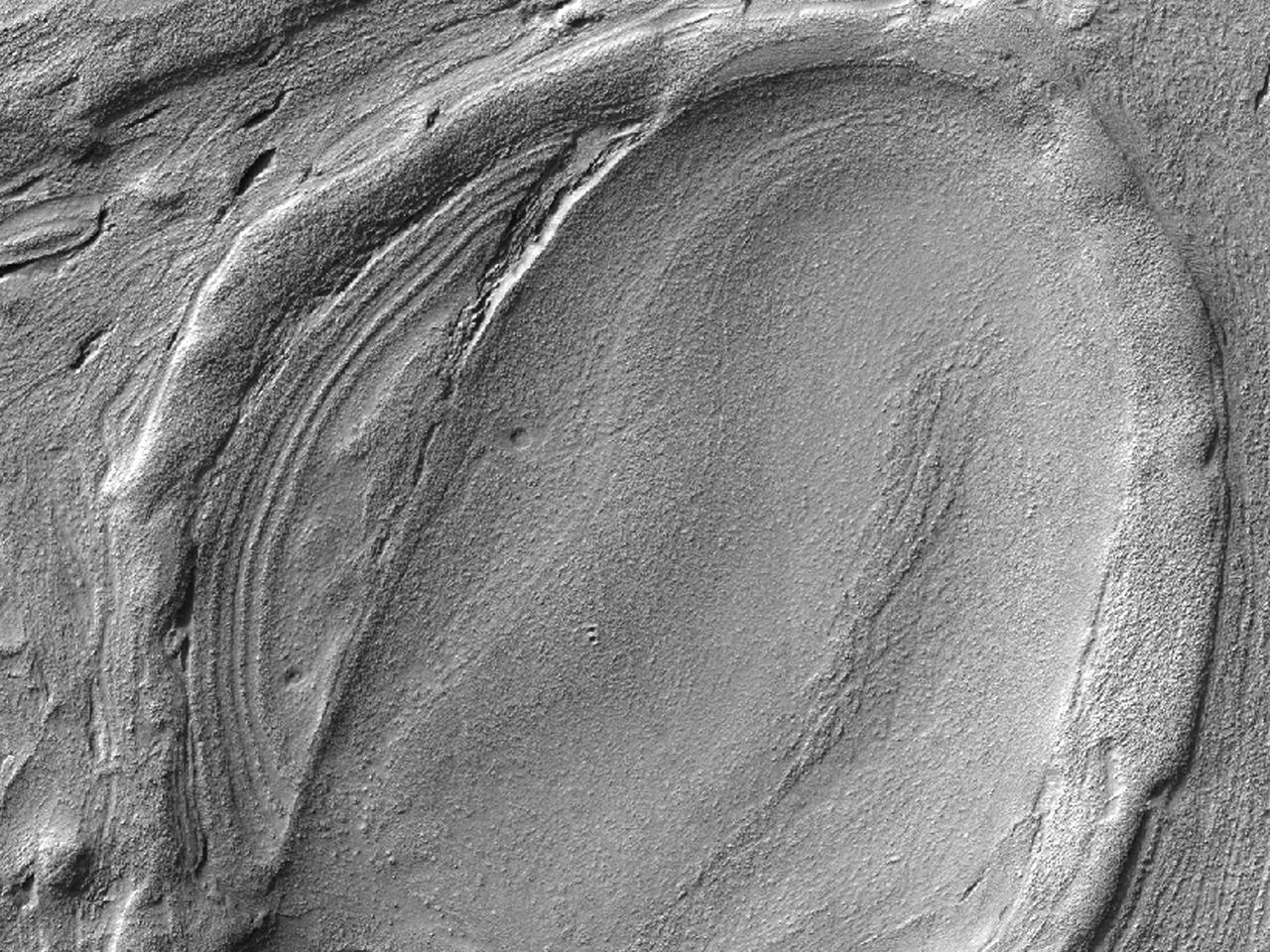 This image from NASA Mars Reconnaissance Orbiter shows some of the weirdest and least-understood landscapes on Mars are on the floor of the deep Hellas impact basin.