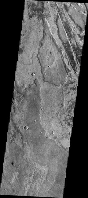 Just as on Earth, volcanism and tectonism are found together on Mars. In this image from NASA 2001 Mars Odyssey spacecraft the ridges and fractures of Claritas Fossae are affecting or perhaps hosting the volcanic flows of Solis Planum.