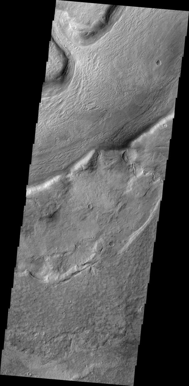 This image from NASA 2001 Mars Odyssey spacecraft shows several large channels emptying into the eastern Hellas Basin. These southern channels are filled with material today. Whether the material contains volitiles like ice is unknown.