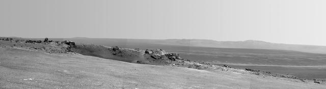 This scene captured by NASA Mars Exploration Rover Opportunity shows the Spirit Point area of the rim, including a small crater, Odyssey on the rim, and the interior of Endeavour beyond.
