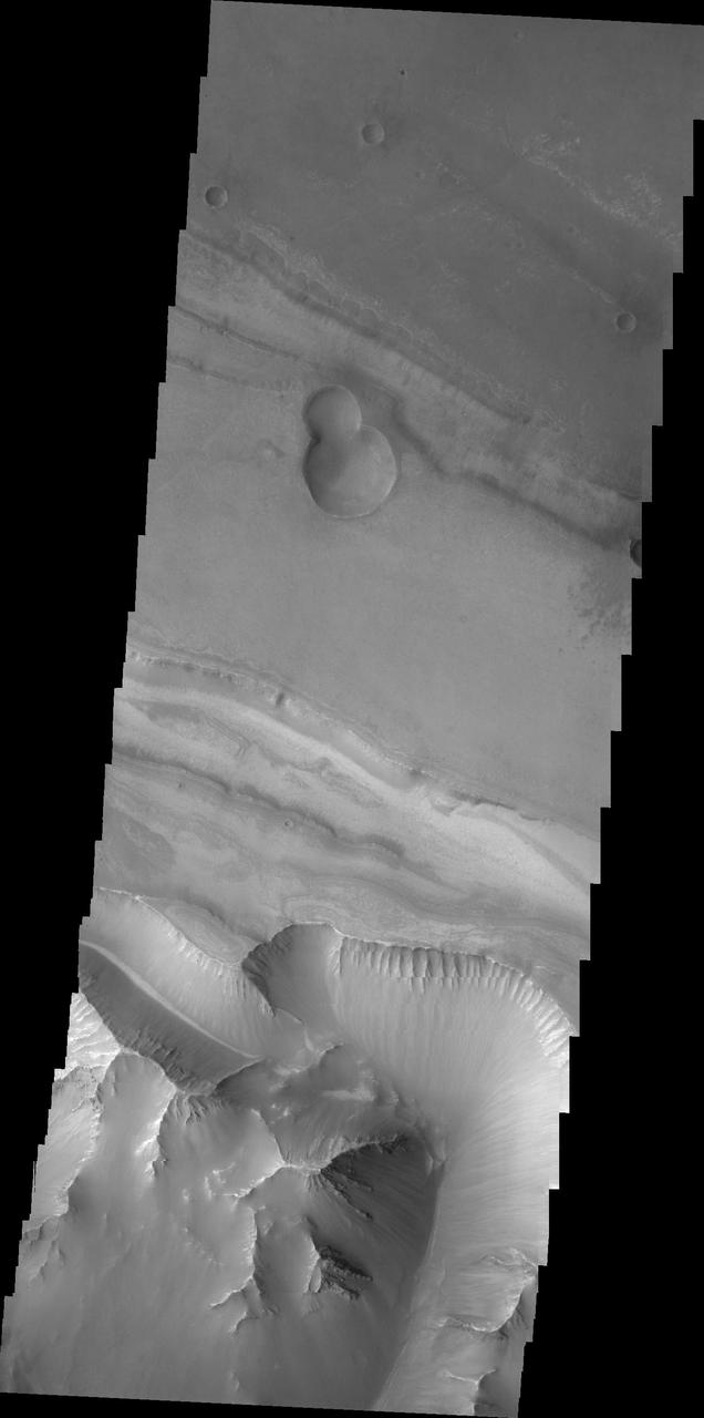 This image captured by NASA 2001 Mars Odyssey spacecraft shows the region between Candor Chasma and Melas Chasma.