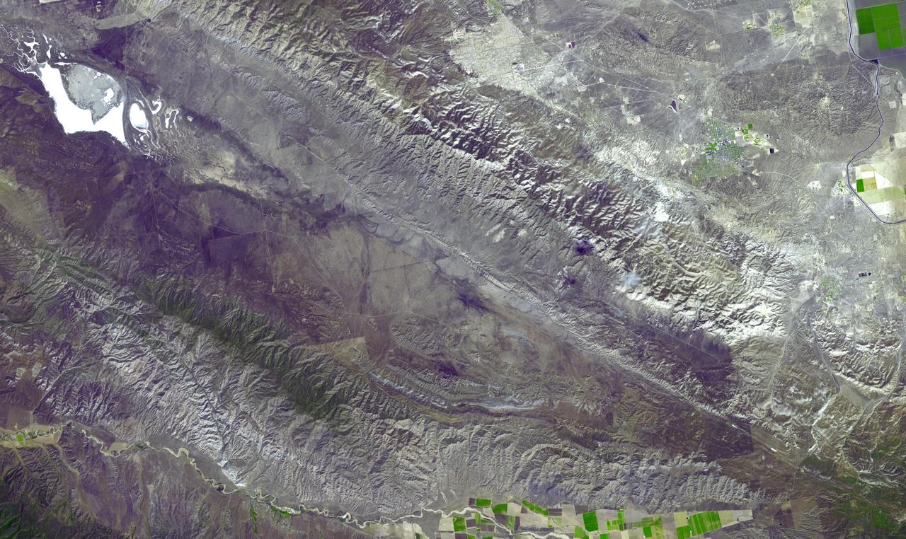 This image acquired by NASA Terra spacecraft shows the Carrizo Plain, located northwest of Los Angeles, CA. It is one of the easiest places to see surface fractures of the San Andreas Fault, evident as it crosses the image from lower right to upper left