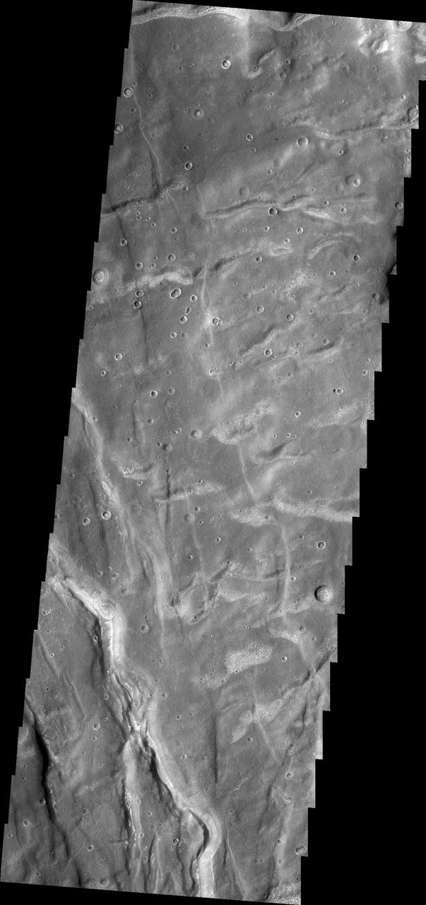 The fractures in this image captured by NASA 2001 Mars Odyssey spacecraft are part of Claritas Fossae. Note the small, bright dunes in the deep furrow on the bottom left of the image.