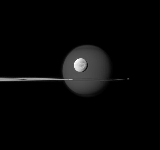 A quartet of Saturn moons, from tiny to huge, surround and are embedded within the planet rings in this Cassini composition. Saturn largest moon, Titan, in the background, and the moon north polar hood is clearly visible.