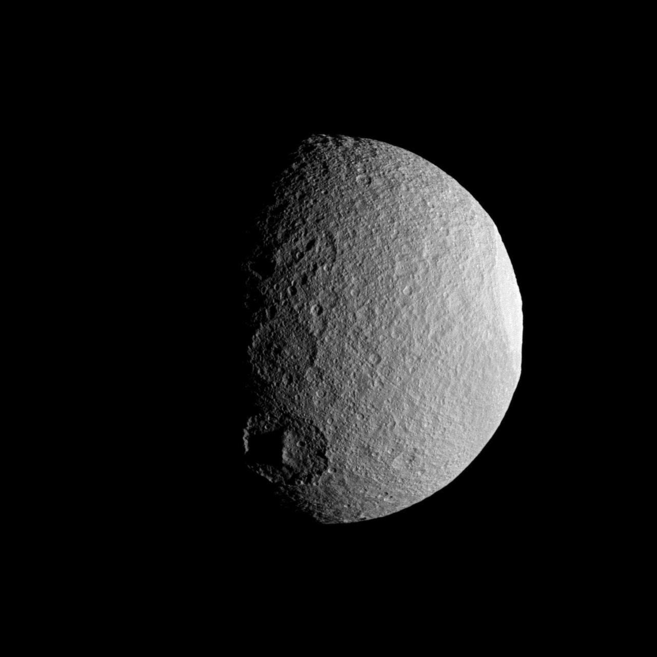 NASA Cassini spacecraft takes a close look at a row of craters on Saturn moon Tethys during the spacecraft April 14, 2012, flyby of the moon. Three large craters are visible along the terminator between day and night on Tethys.