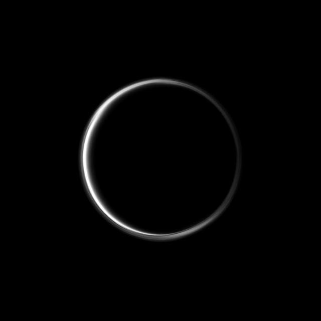 NASA Cassini spacecraft looks toward the dark side of Saturn largest moon and captures the halo-like ring produced by sunlight scattering through the periphery of Titan atmosphere.