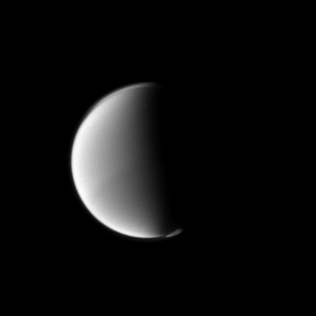 Titan south polar vortex seems to float above the moon south pole in this Cassini spacecraft view. The vortex, which is a mass of gas swirling around the south pole high in the moon atmosphere, can be seen in the lower right of this view.