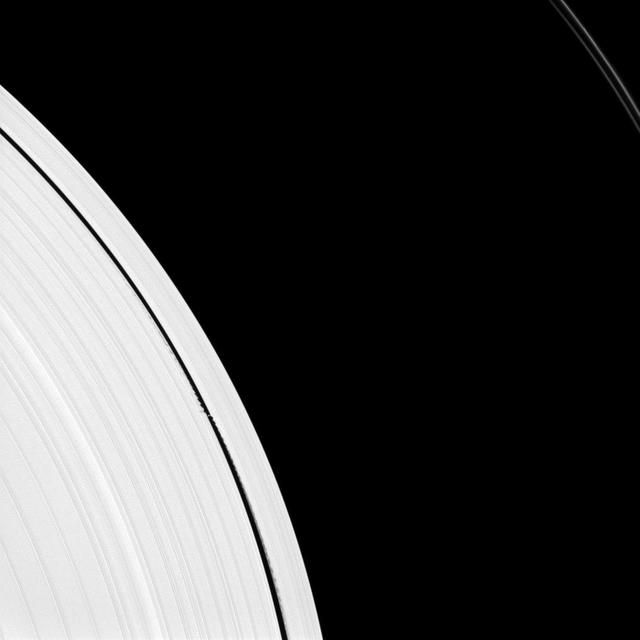 Saturn small moon Daphnis is caught in the act of raising waves on the edges of the Keeler gap, which is the thin dark band in the left half of the image. Waves like these allow scientists to locate small moons in gaps and measure their masses.