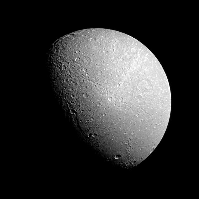 The famed wispy terrain on Saturn moon Dione is front and center in this recent image captured by NASA Cassini spacecraft. The wisps are fresh fractures on the trailing hemisphere of the moon icy surface.