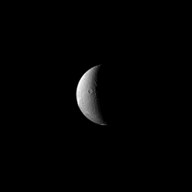 In this recent view of Dione, the Cassini spacecraft looks on as the moon slow rotation brings the terrain from day into night. Dione rotation period is 66 hours.