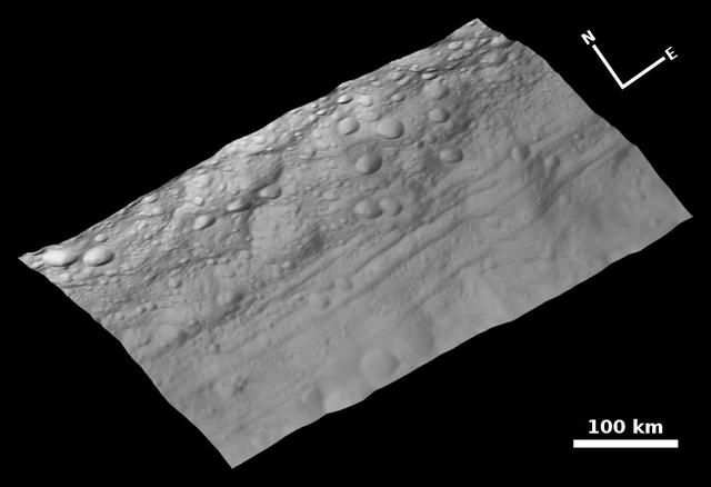 This view of the topography of asteroid Vesta surface is composed of several images obtained with the clear filter in the framing camera on NASA Dawn spacecraft on August 6, 2011. The image has a resolution of about 260 meters per pixel.
