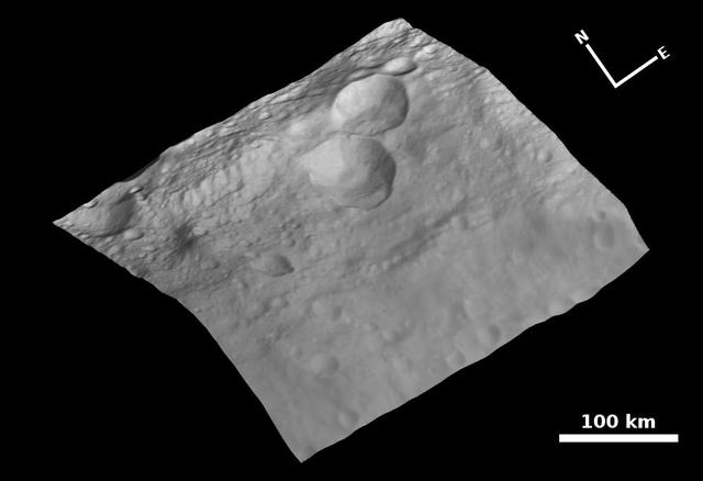 This view of the topography of asteroid Vesta surface is composed of several images obtained with the framing camera on NASA Dawn spacecraft on August 6, 2011. The image mosaic is shown superimposed on a digital terrain model.
