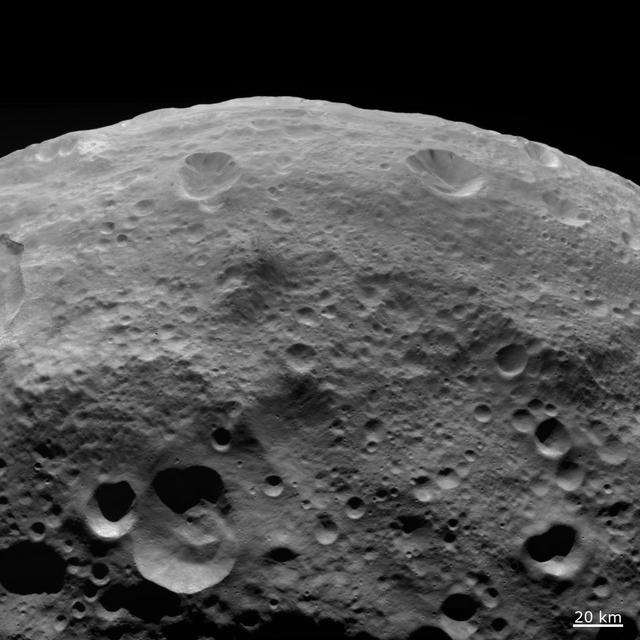 NASA Dawn spacecraft obtained this image of dark material on hilltops on asteroid Vesta with its framing camera on August 18, 2011. The image has a resolution of about 260 meters per pixel.