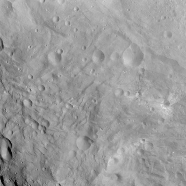 NASA Dawn spacecraft obtained this image of craters and grooves in the south polar region on asteroid Vesta with its framing camera on Sept. 3, 2011. The image has a resolution of about 220 meters per pixel.