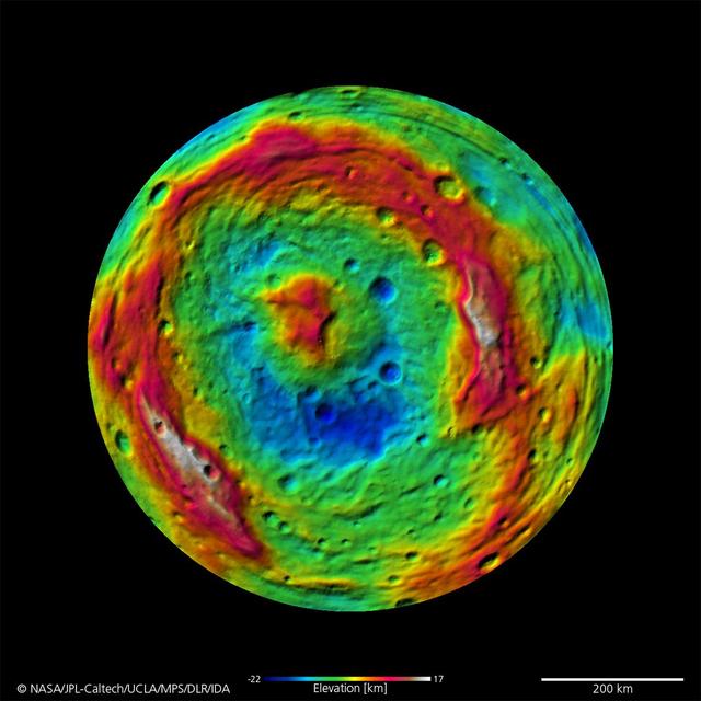 The terrain model of Vesta southern hemisphere shows a big circular structure, its rim rising above the interior of the structure. This false-color map of the giant asteroid Vesta is from the framing camera aboard NASA Dawn spacecraft.